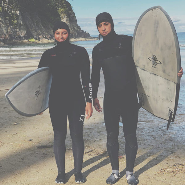 Surfers Izzi Gomez and Dave Boehne holding their Infinity Surfboards